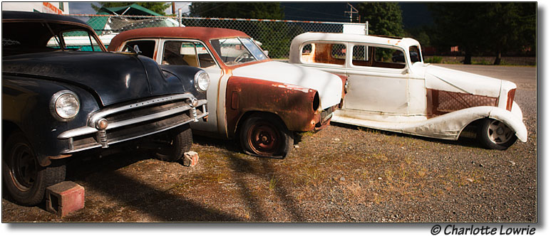 Three antique cars